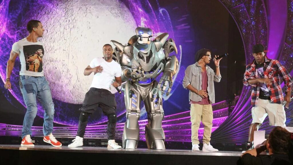 Titan the Robot rehearses with the boyband JLS who are all dressed casually