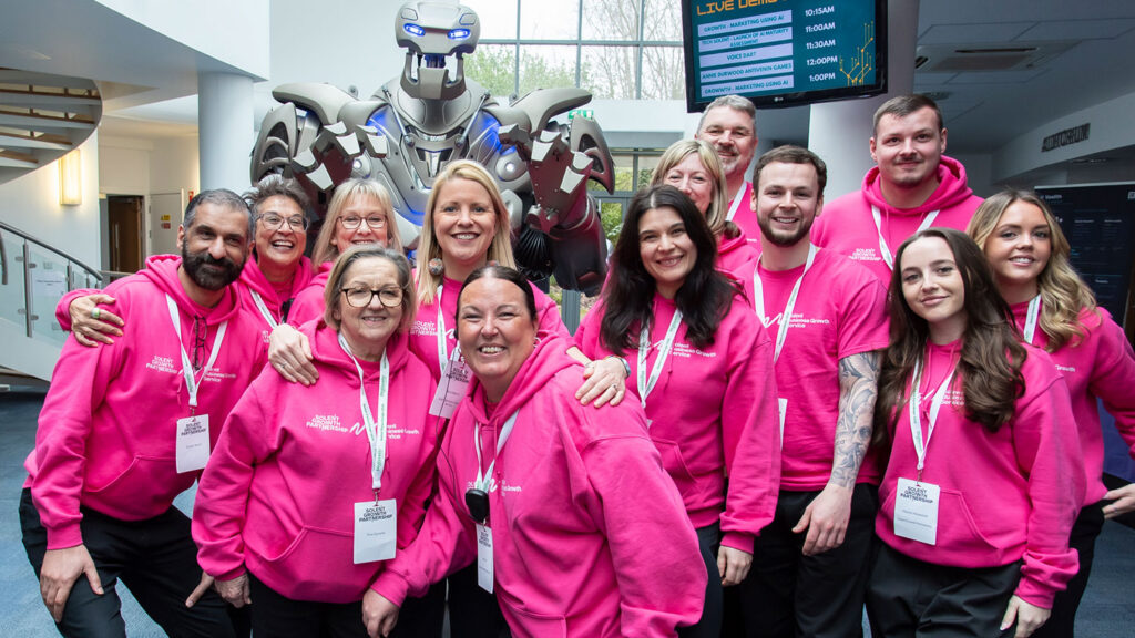 titan the robot poses for a photograph with the smiling staff of the futurescape 2026 event on the solent.