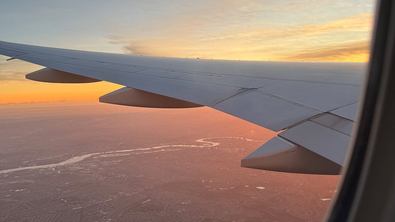 View from the cabin of a passenger plane flying over the City of London, UK