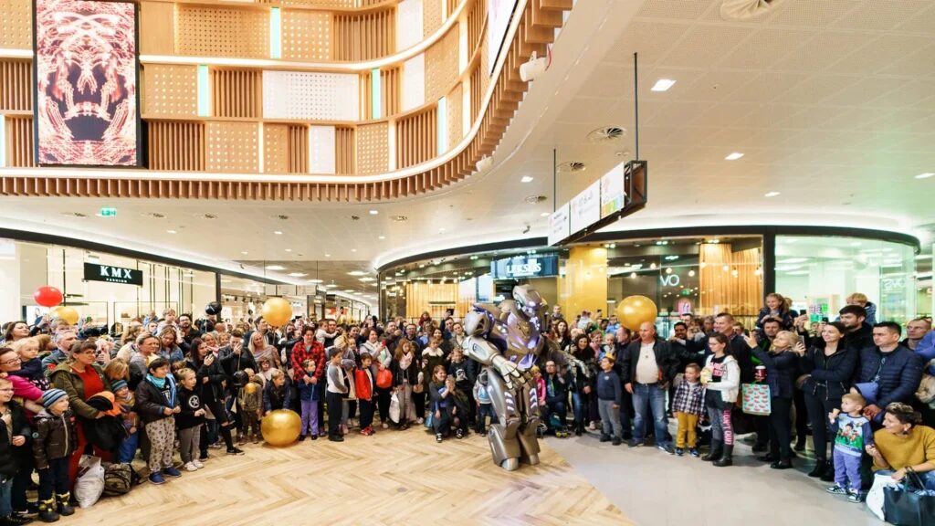Titan performs in a large shopping mall atrium