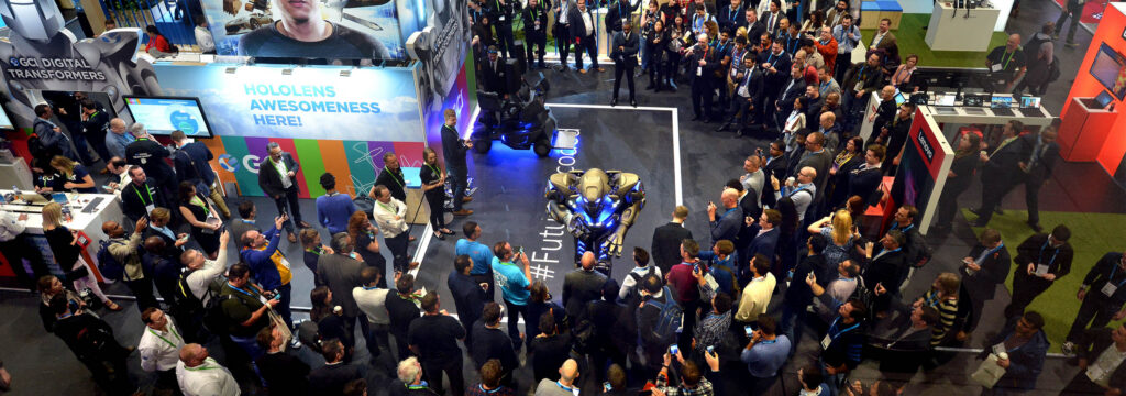 Titan the robot is surrounded by a huge crowd on a stand, while performing at the london Excel Trade Show